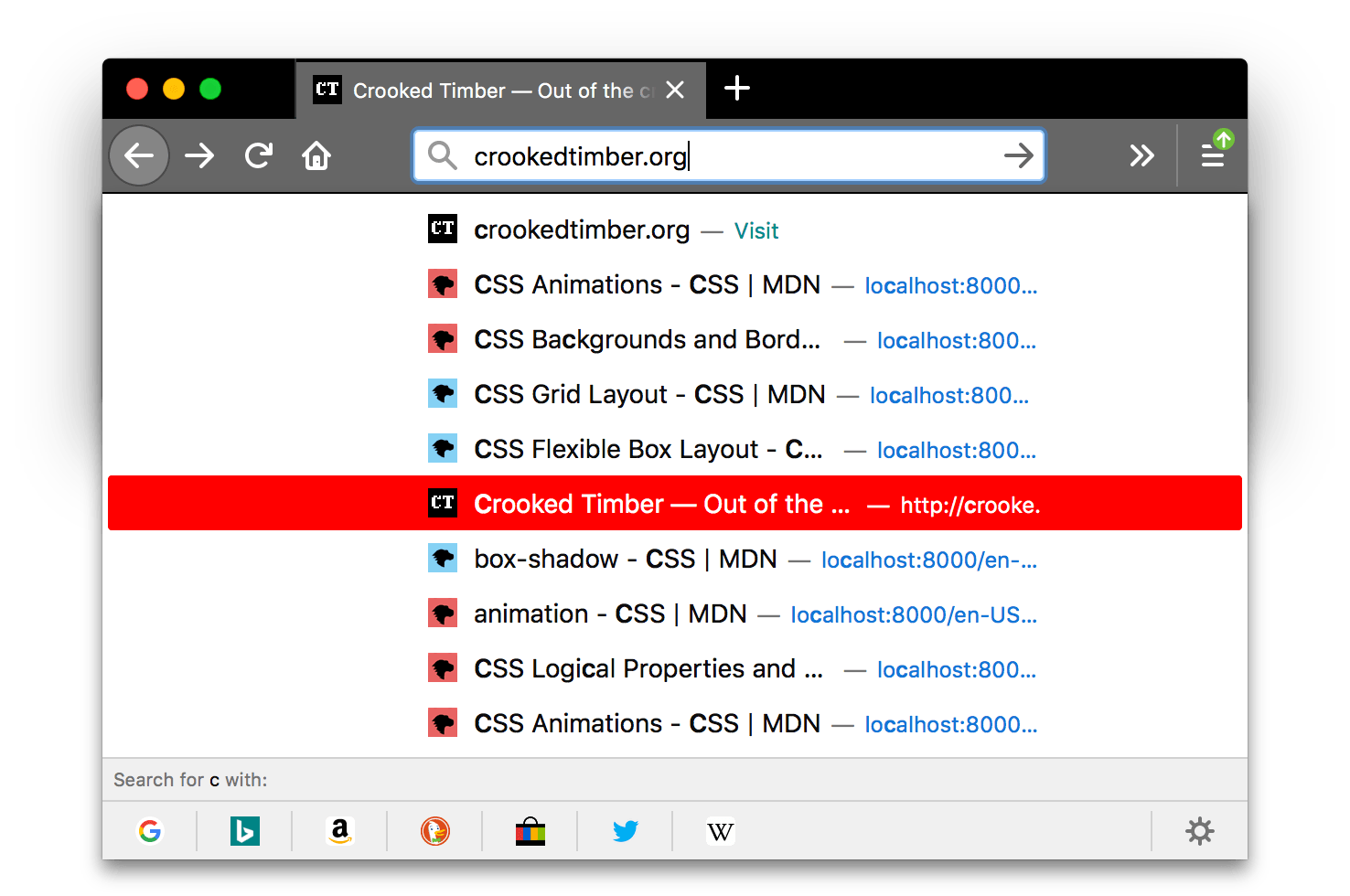 Screenshot von Firefox mit schwarzem Browserfenster. Die Tabs und die URL-Leiste sind heller grau mit weißen Symbolen und weißem Text. Ein Popup mit Suchergebnissen wird angezeigt; der Hintergrund eines hervorgehobenen Eintrags ist rot.